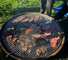Load image into Gallery viewer, Cooking on the fire pit with a stainless steel grill