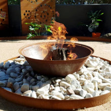 Load image into Gallery viewer, Fire pit with flames surrounded by stones in an outdoor setting
