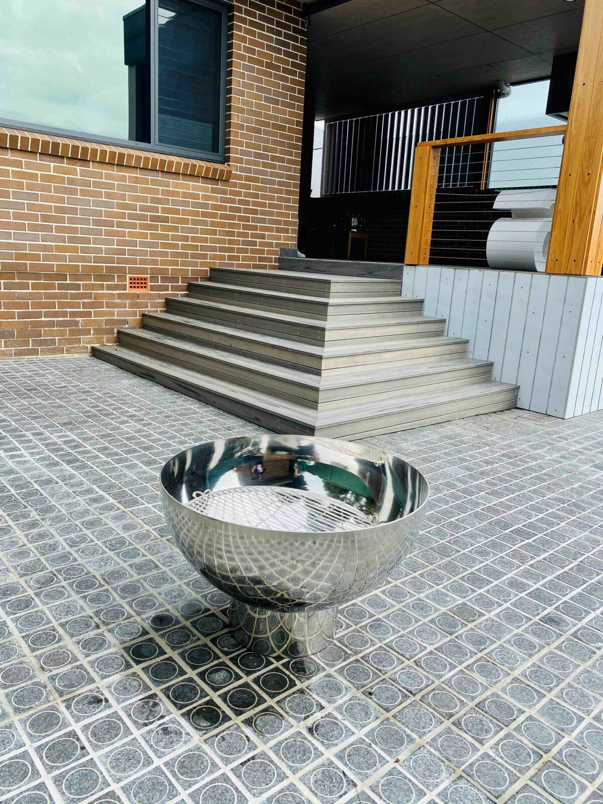 The Goblet Fire Pit – Stainless Steel in yard