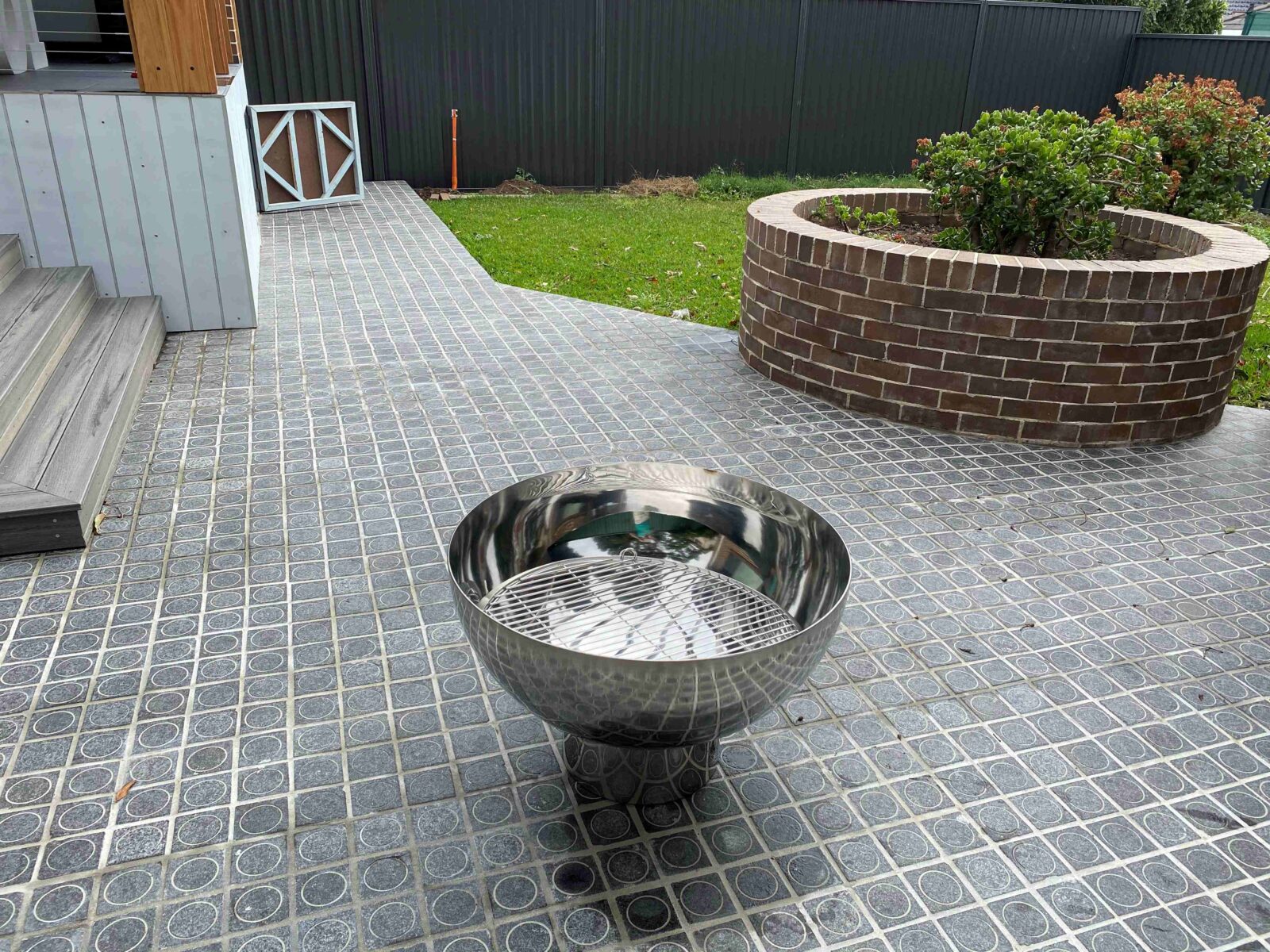 The Goblet Fire Pit – Stainless Steel in yard