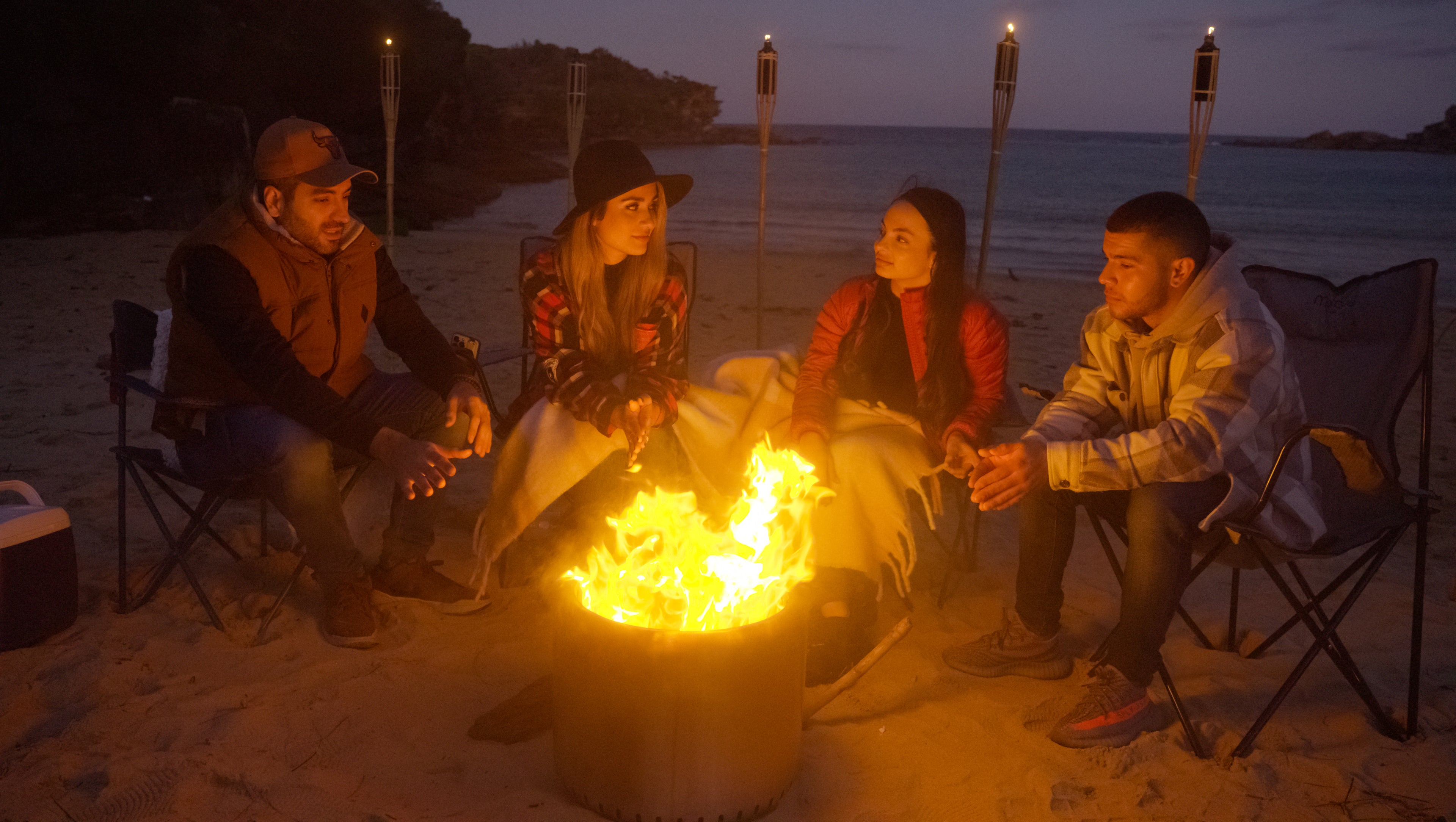 People gathering around the Ecoflame Smokeless fire pit