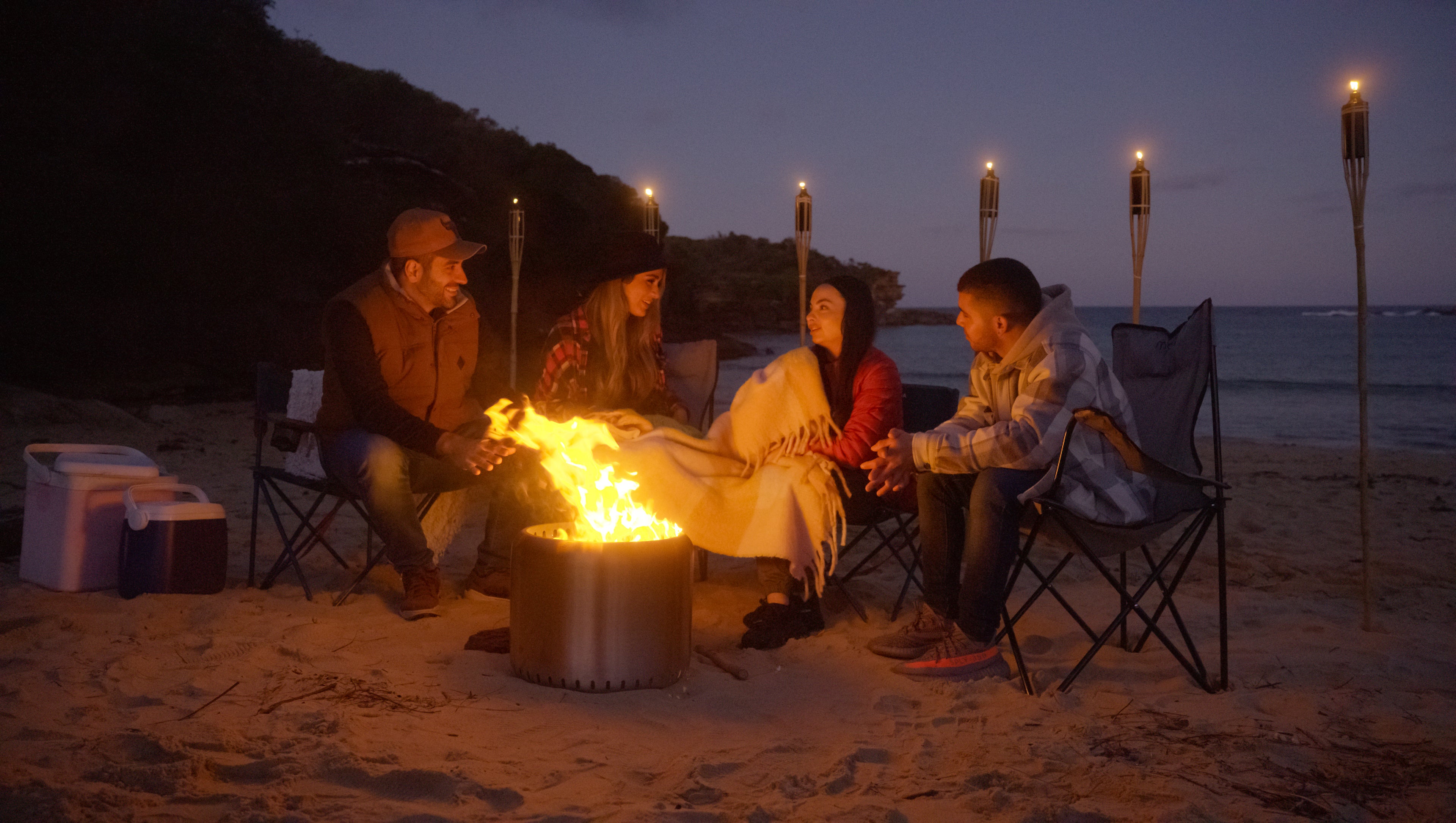 People gathering around the Ecoflame Smokeless fire pit