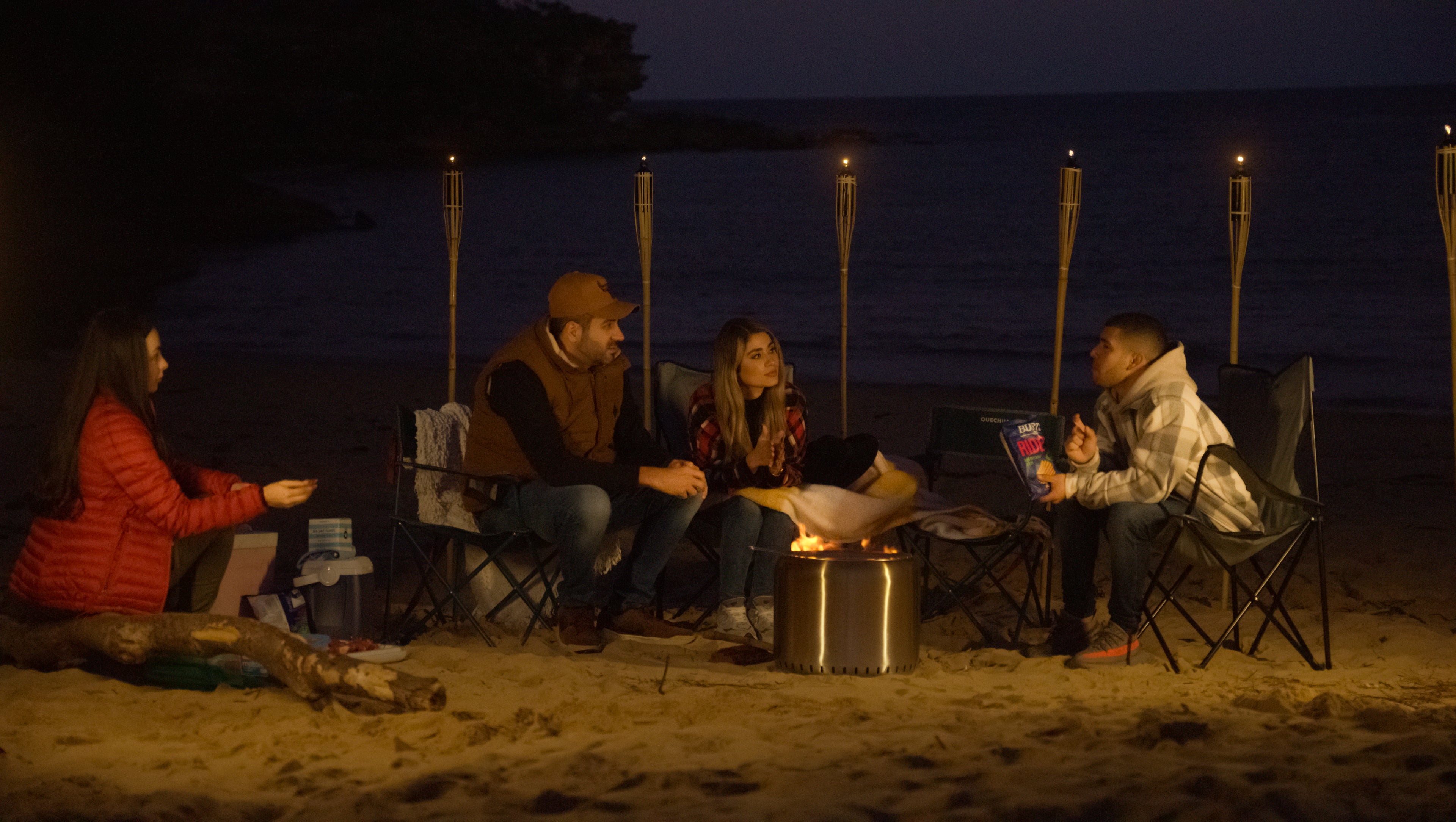 People gathering around the Ecoflame Smokeless fire pit