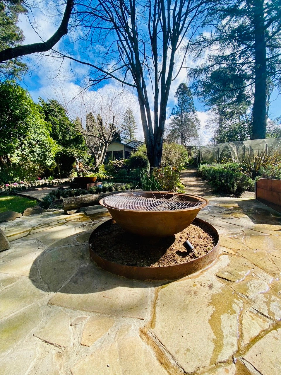 The Basin Cast Iron Fire Pit - 1200mm in the yard
